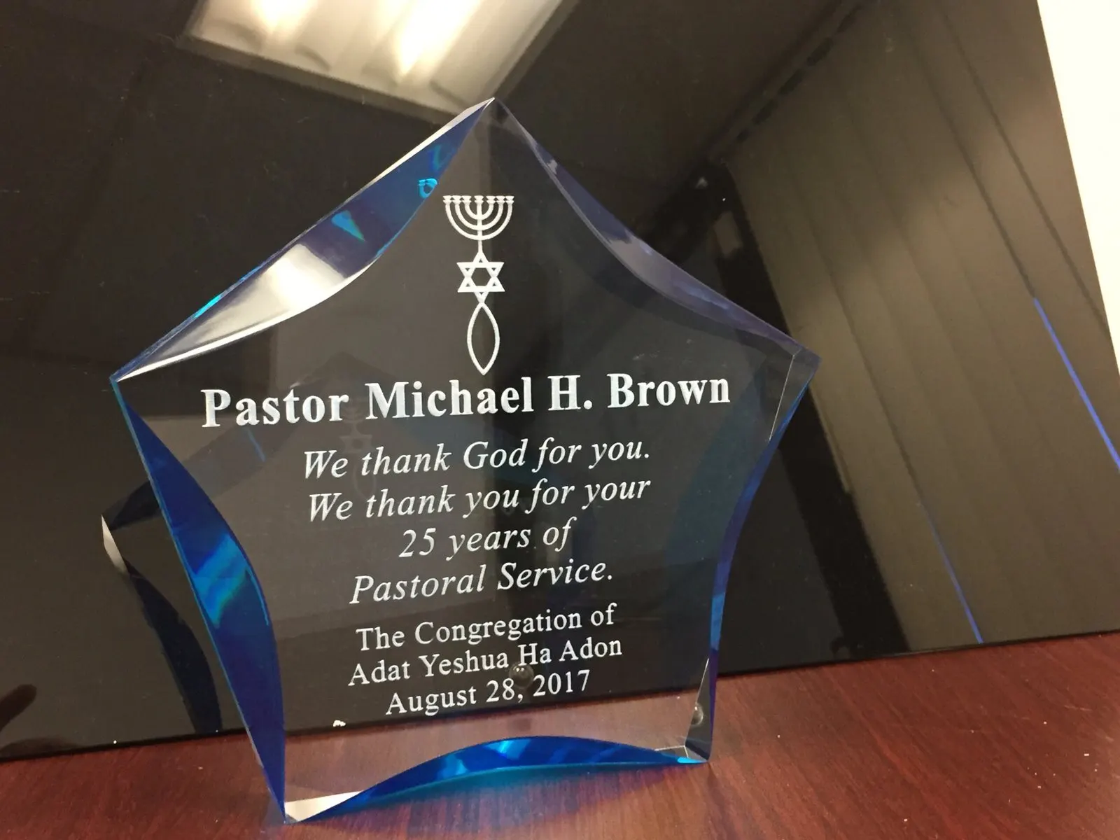 Engraved star award for 25 years of service.