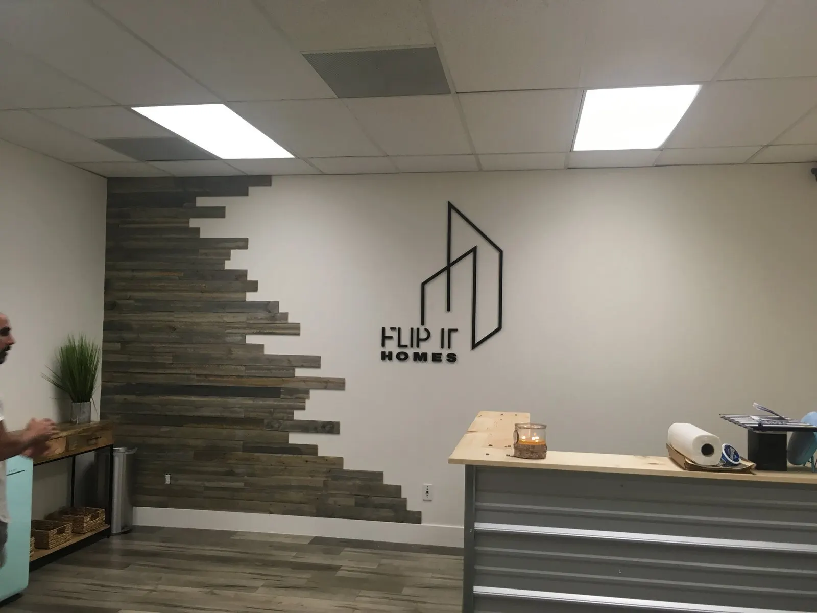 Letters on a feature wall behind the desk.