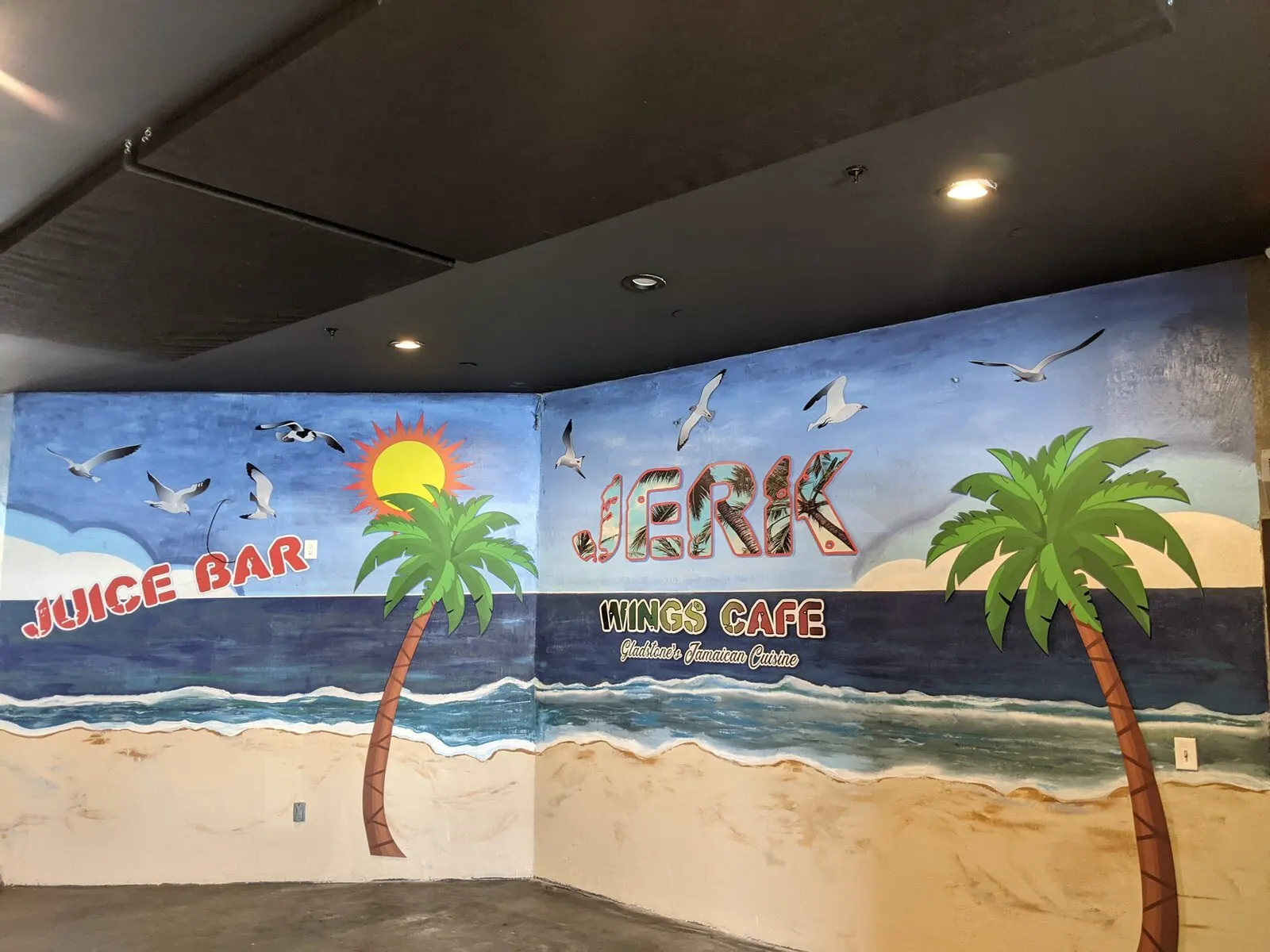 Printed wall mural around a juice bar.