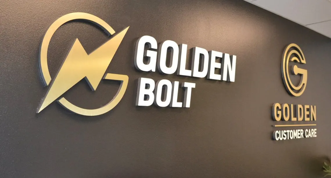 Dimensional logo and letters behind a reception desk.
