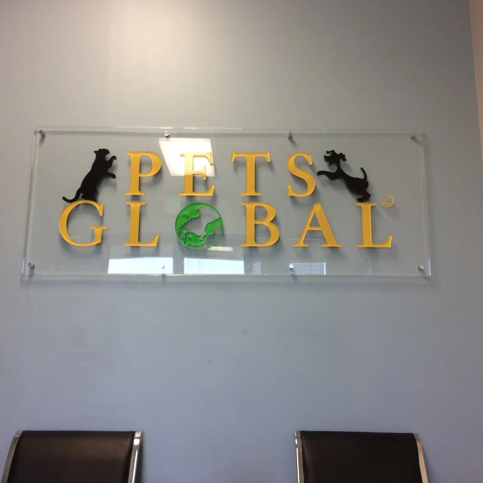 Letters and logo on a clear acrylic panel.