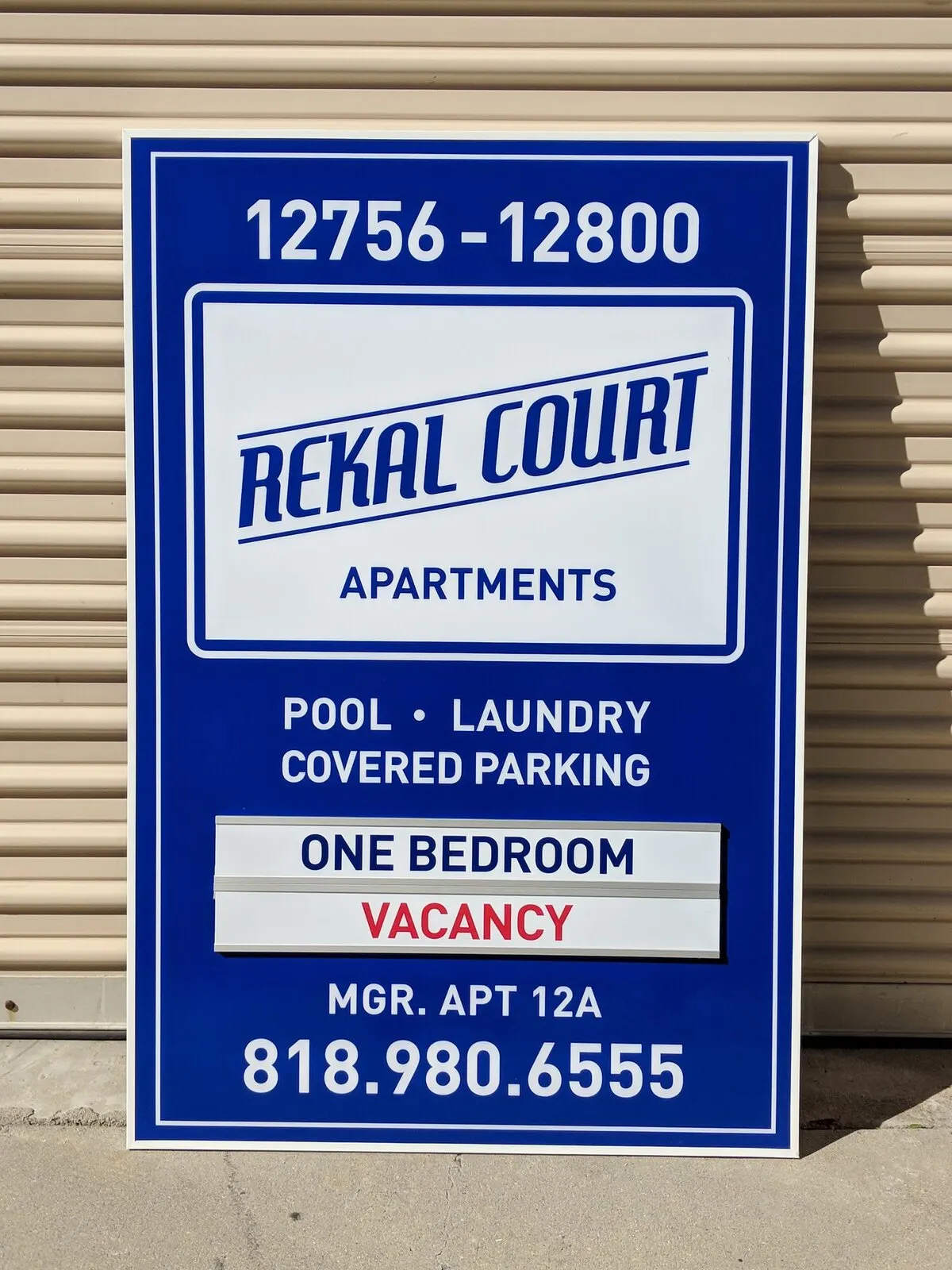 Post-mounted aluminum sign with a changeable vacancy panel.