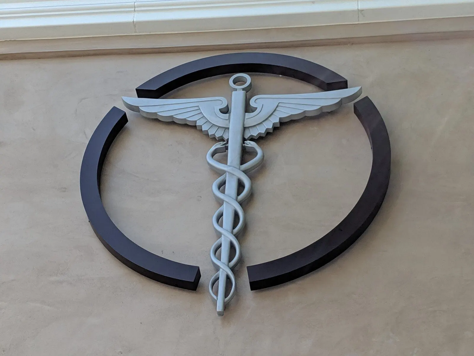 Cut aluminum emblem, mounted on standoffs.