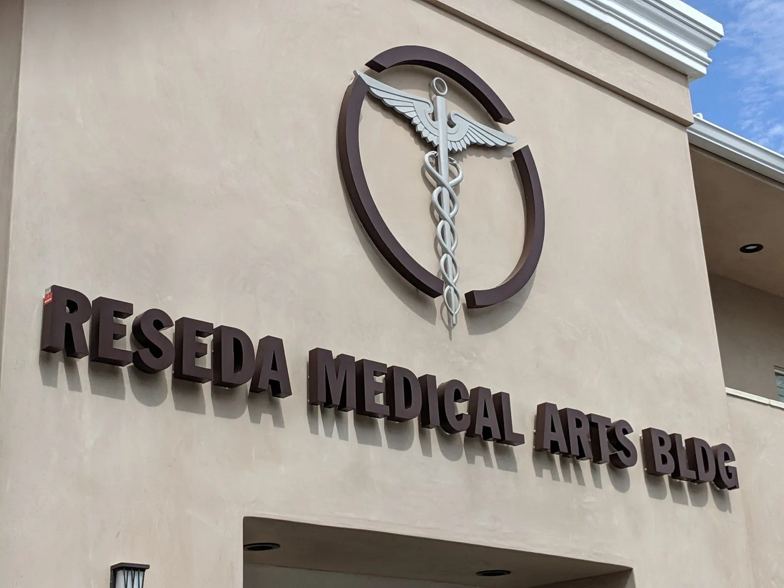 Building letters and a caduceus mark on the tower.
