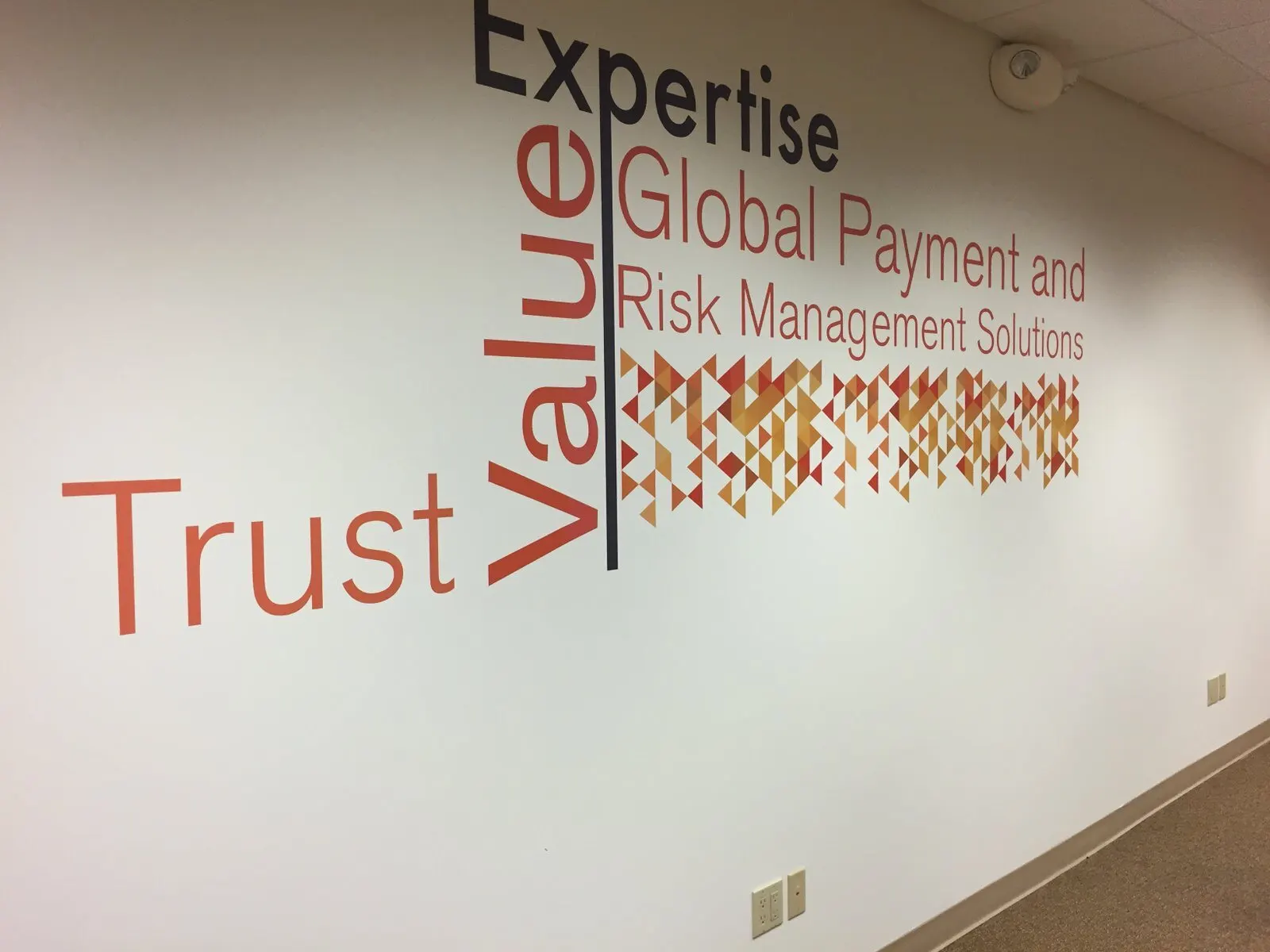 Cut vinyl lettering and graphics in a corridor.
