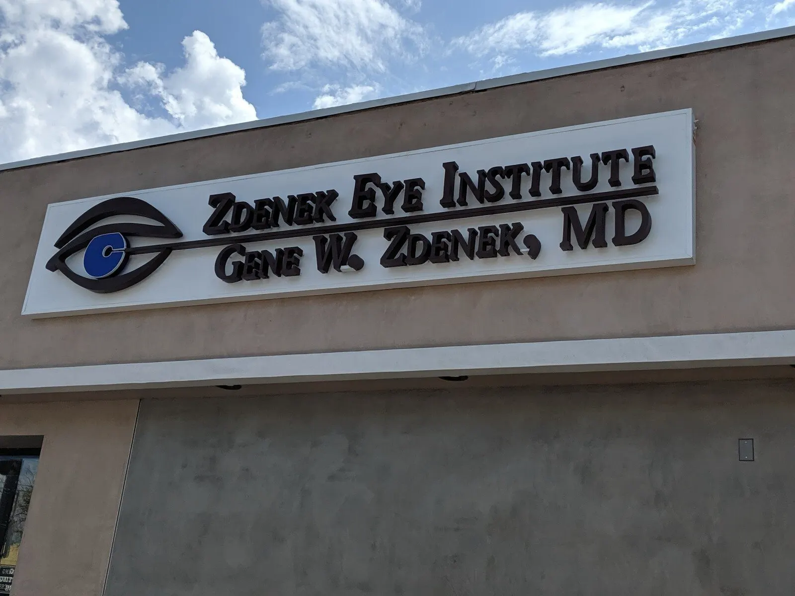 Panel sign with the practice name and logo.