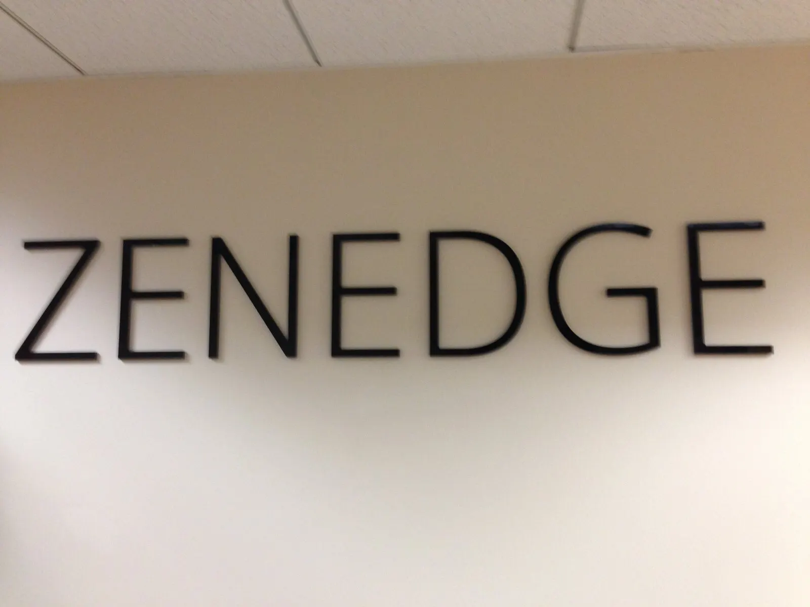 Flat-cut letters on a white wall.